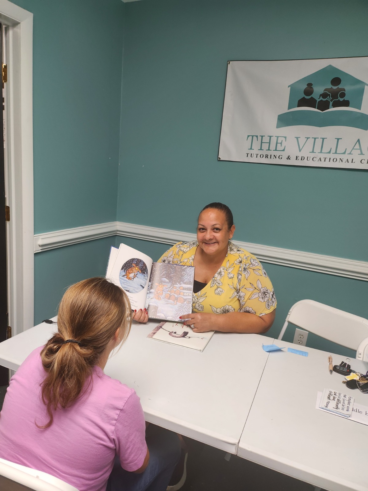 Dr. Cox-Skinner tutoring a student at The Village